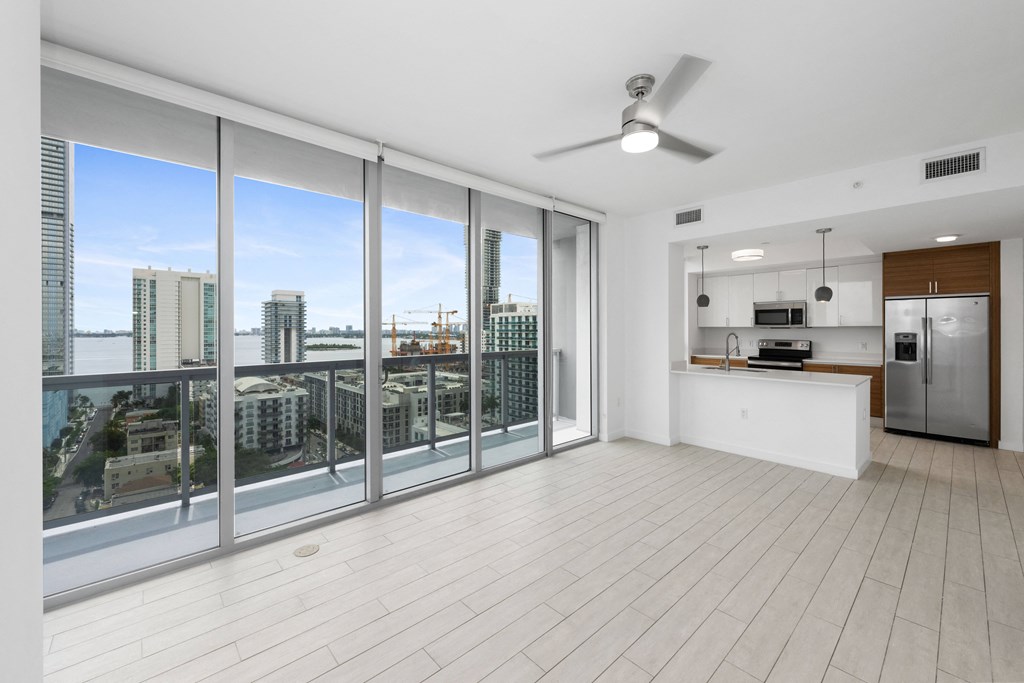 a living room with a large window and a view of a city