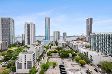a cityscape with tall buildings and a river in the background