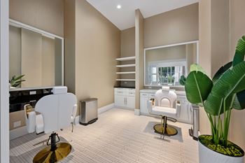 A modern kitchen with a white chair and a plant.