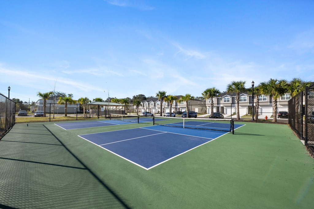 A tennis court with a blue and green surface and white lines.