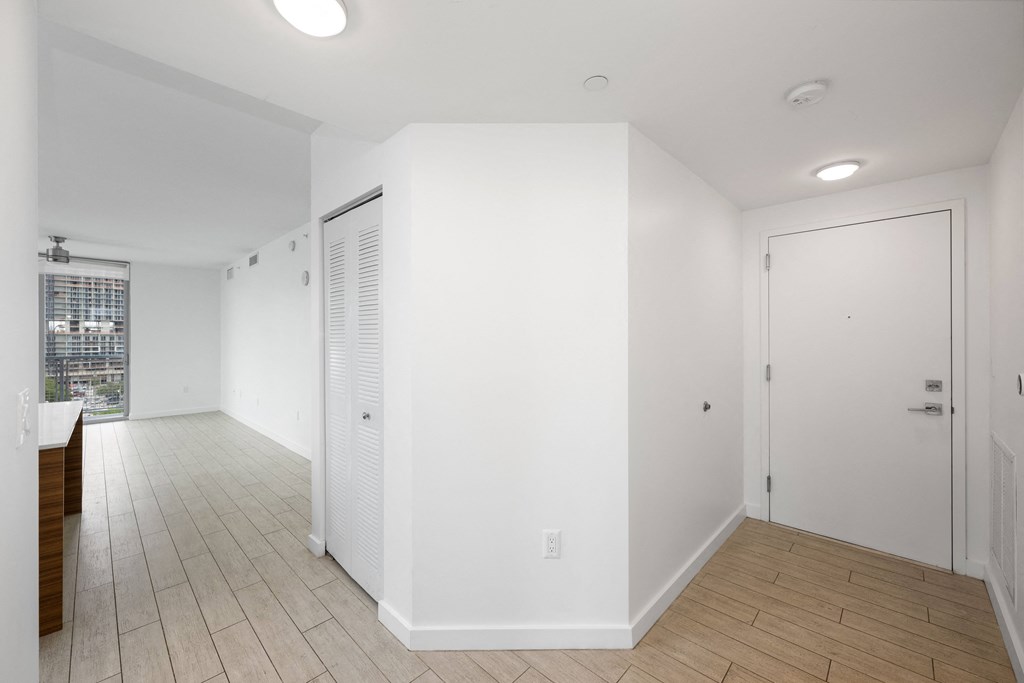 a bedroom with a medium sized bed and a door that leads to a bathroom