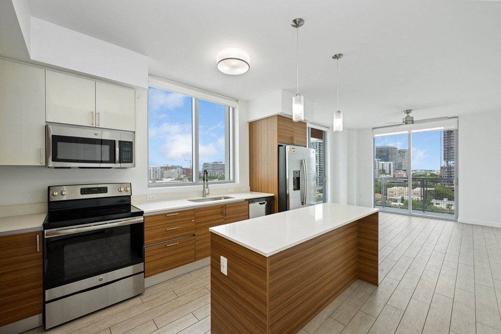 a kitchen with white countertops and wooden cabinets