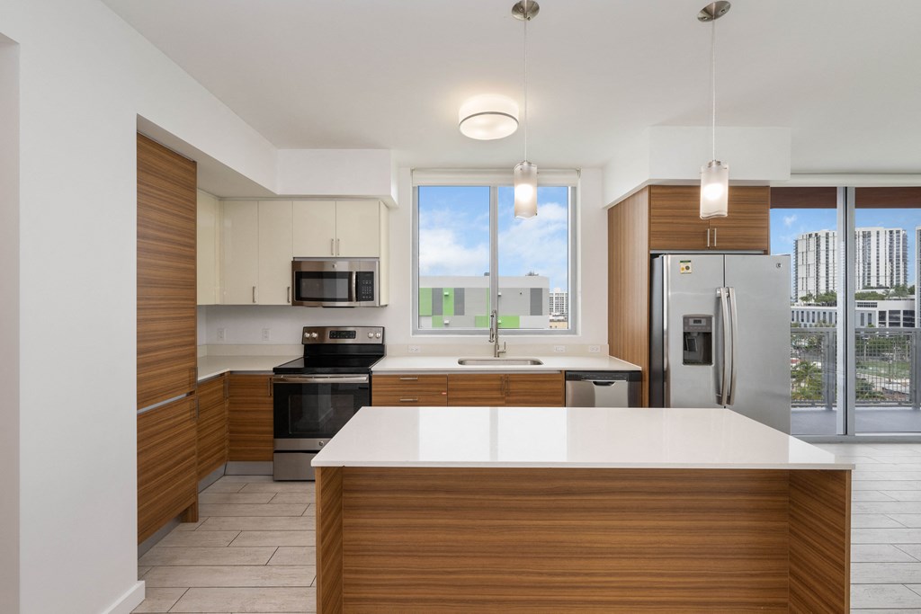 a kitchen with white countertops and wooden cabinets