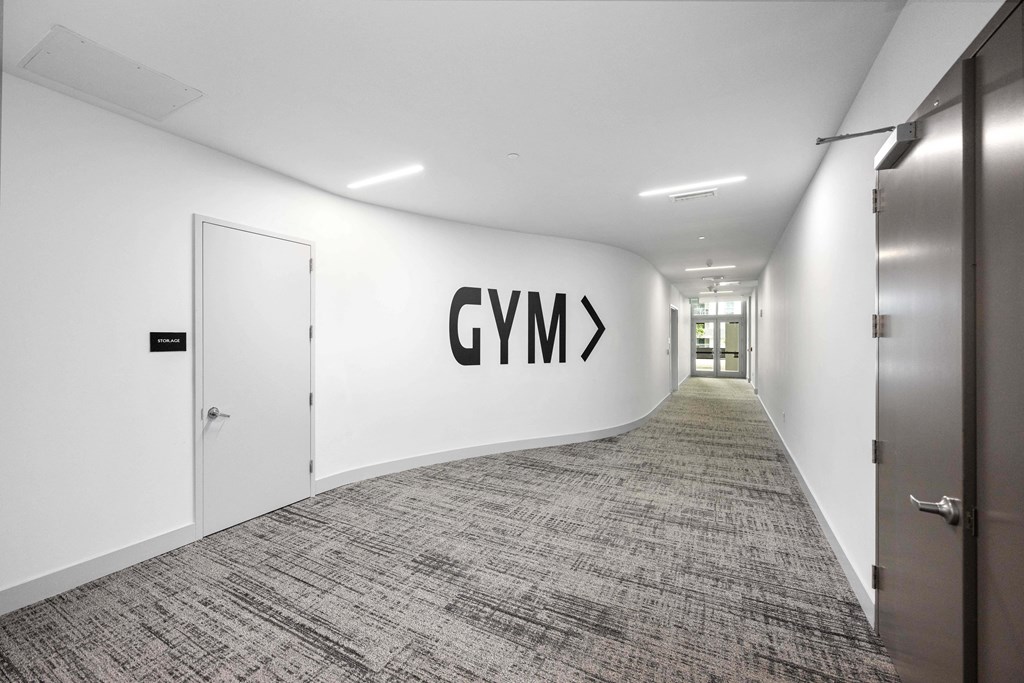 a view down a long corridor with a large logo on the wall
