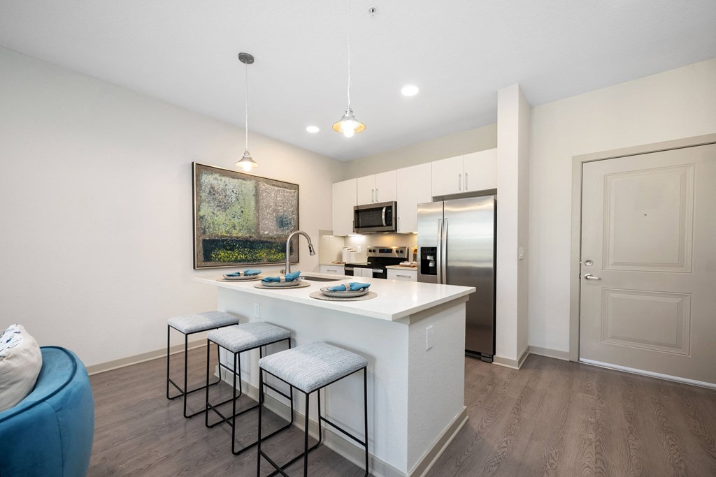 a kitchen with an island and three stools
