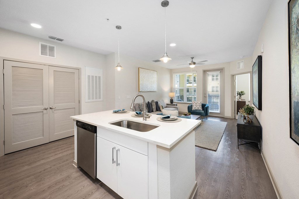kitchen with an island and a living room in the background