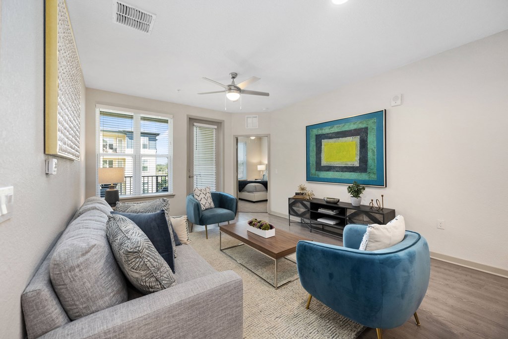 living room with a couch coffee table and a ceiling fan