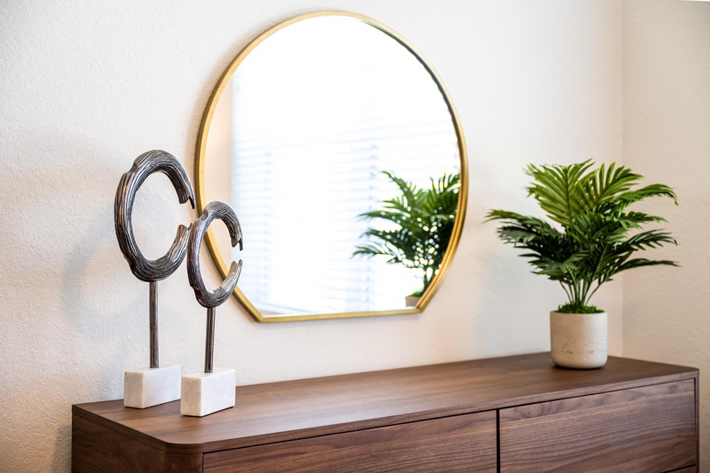 wooden dresser and round mirror