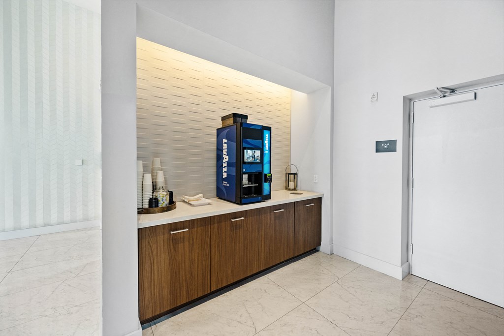 a coffee machine on a counter in a room with a door