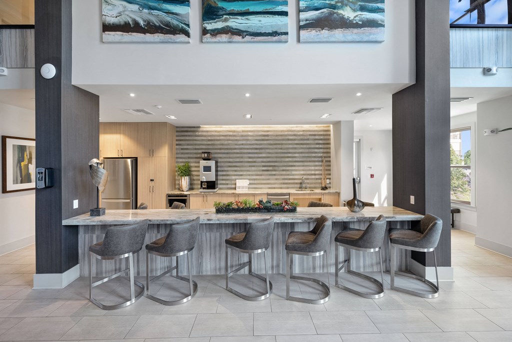 a kitchen with a large center island with a breakfast bar