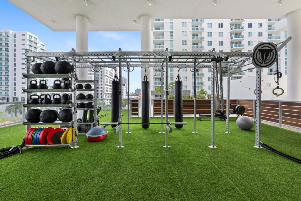 a gym on the roof of a building with weights and other equipment