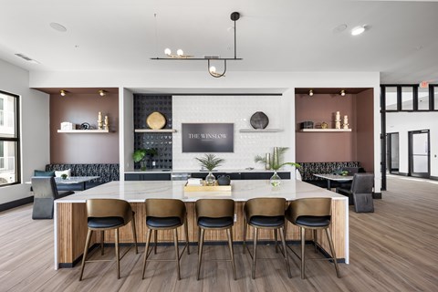 A modern dining room with a large table and chairs.