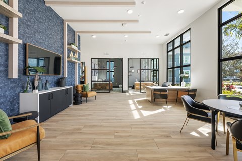 A modern living room with a stone wall and wooden flooring.