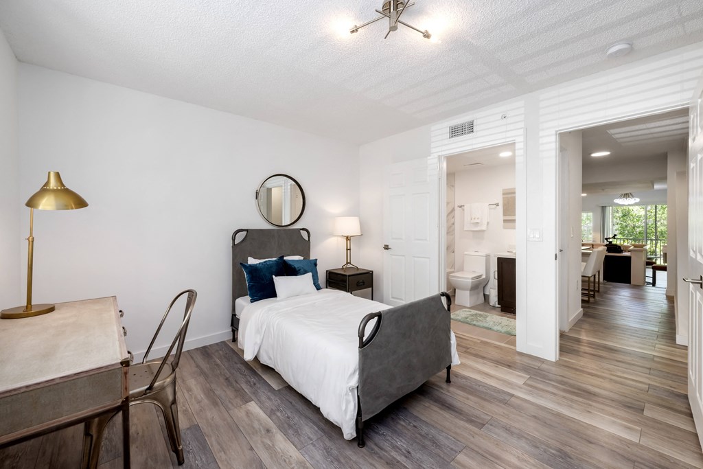 a bedroom with a bed and a desk