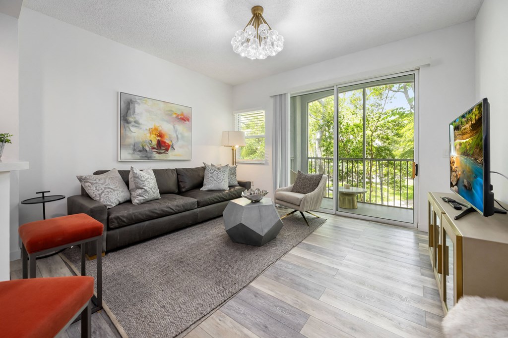 a living room with a couch and a tv and a sliding glass door