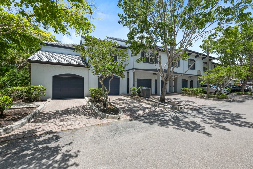 a white house with a driveway and a garage door