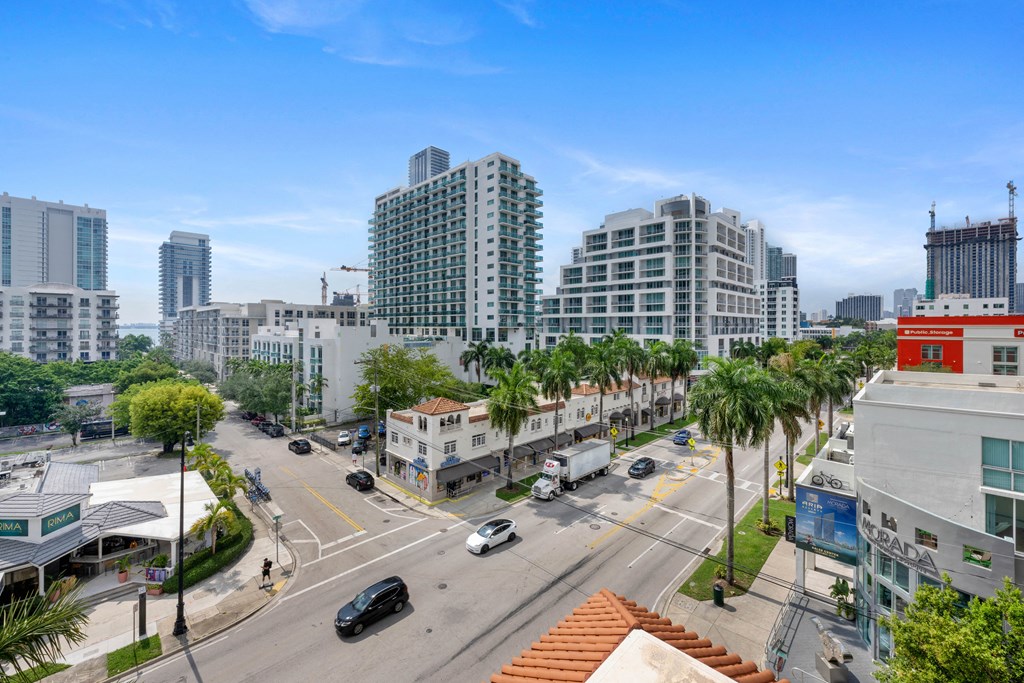an aerial view of a city street with tall buildings and palm trees