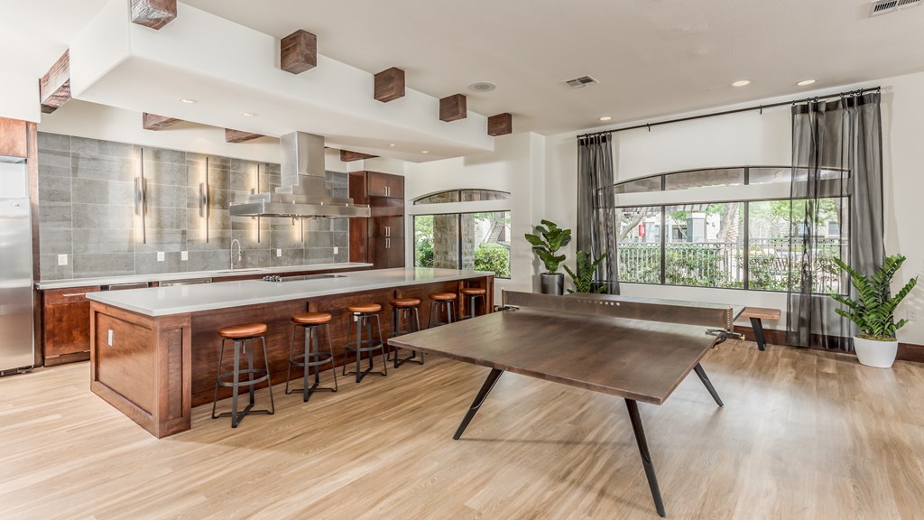 A modern kitchen with a wooden island and bar stools.