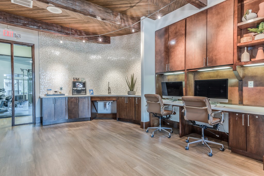 A wood and tile office space with a desk and chairs.