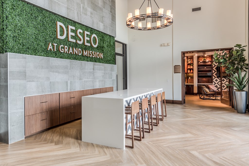 A reception area with a green wall and a white reception desk.