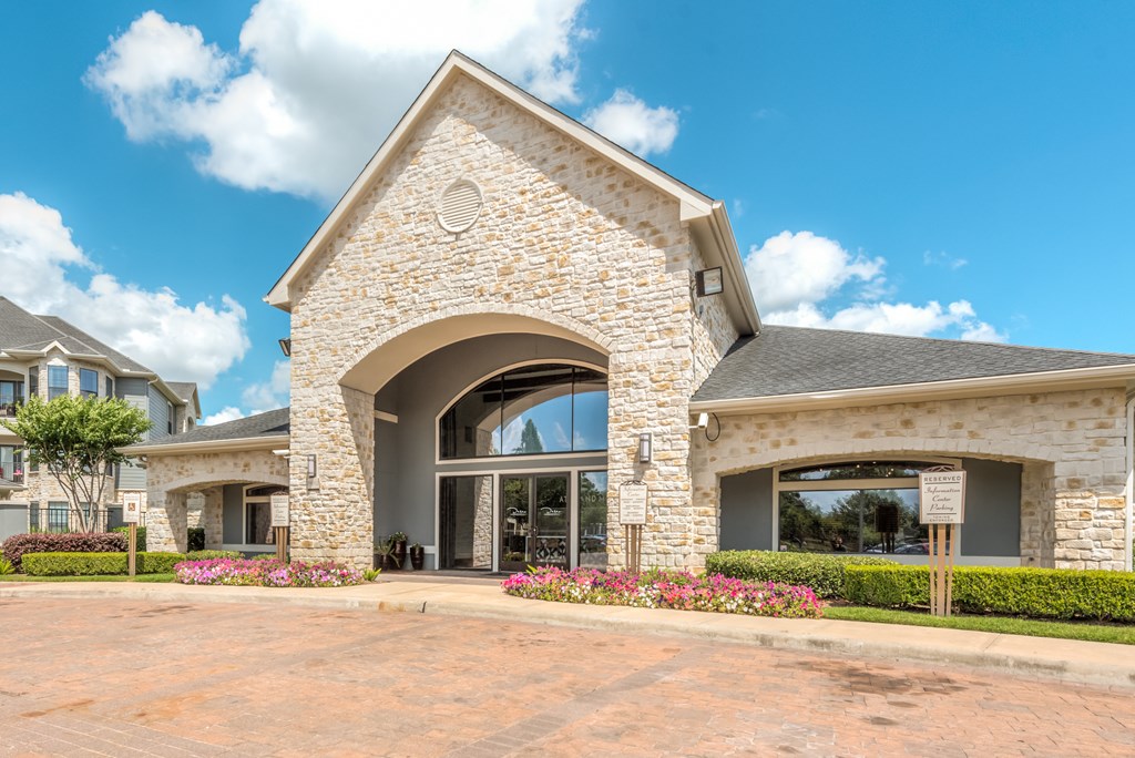 A house with a stone archway entrance and a grey roof.