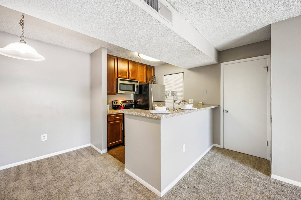 a kitchen with a counter top and a refrigerator