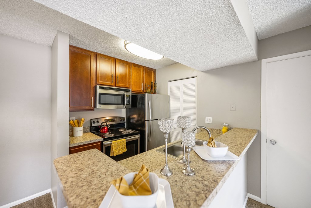 a kitchen with granite counter tops and stainless steel appliances