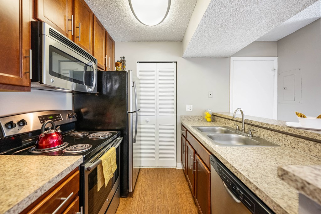 a kitchen with a sink and stove and a refrigerator