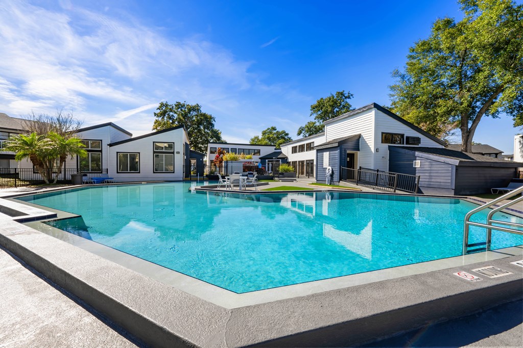 a swimming pool with houses in the background