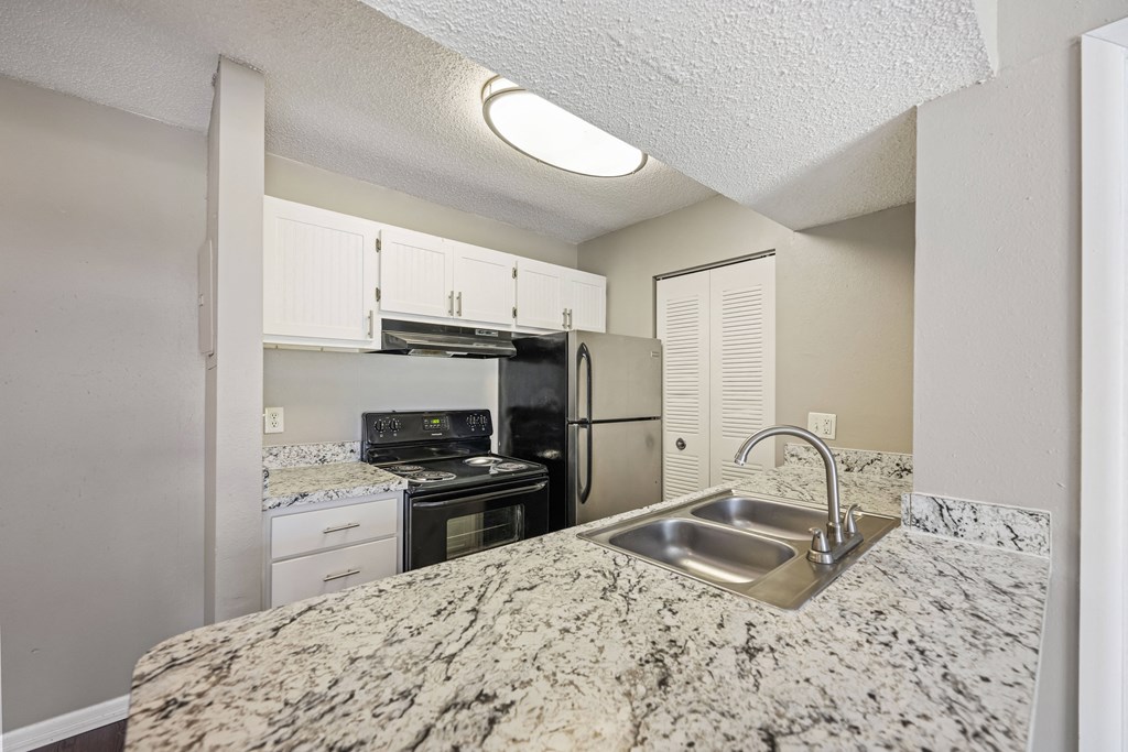 a kitchen with granite counter tops and a sink