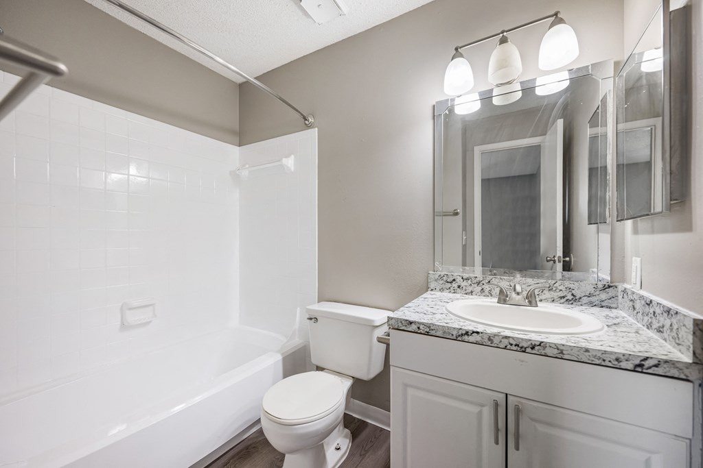 an empty bathroom with a sink toilet and shower