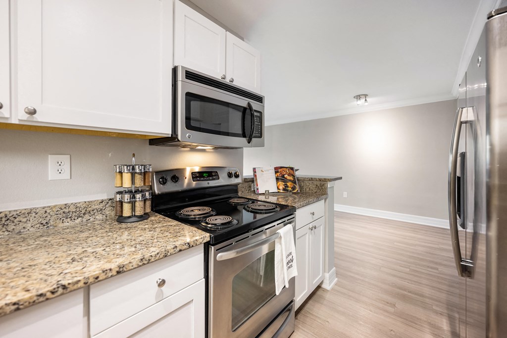 a kitchen with stainless steel appliances and granite counter tops