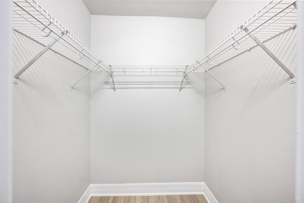 our spacious walk in closets are equipped with wire shelving and a wood floor