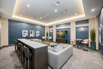 a large room with a large couch and a long table in the middle of it