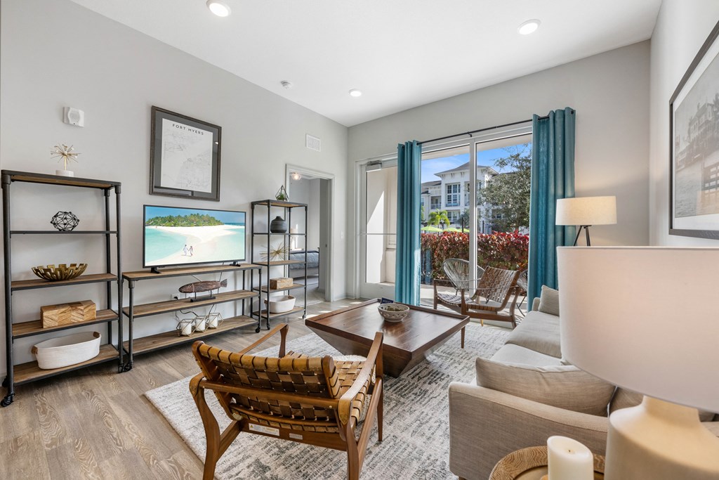 a living room with a couch and chairs and a tv