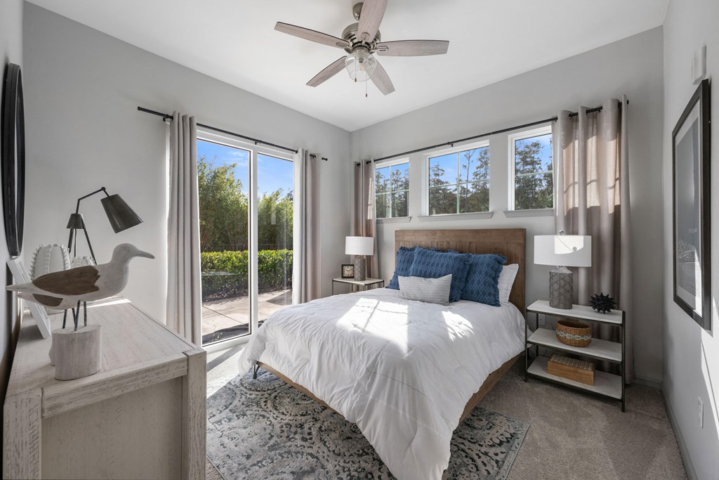 a bedroom with a bed and a ceiling fan