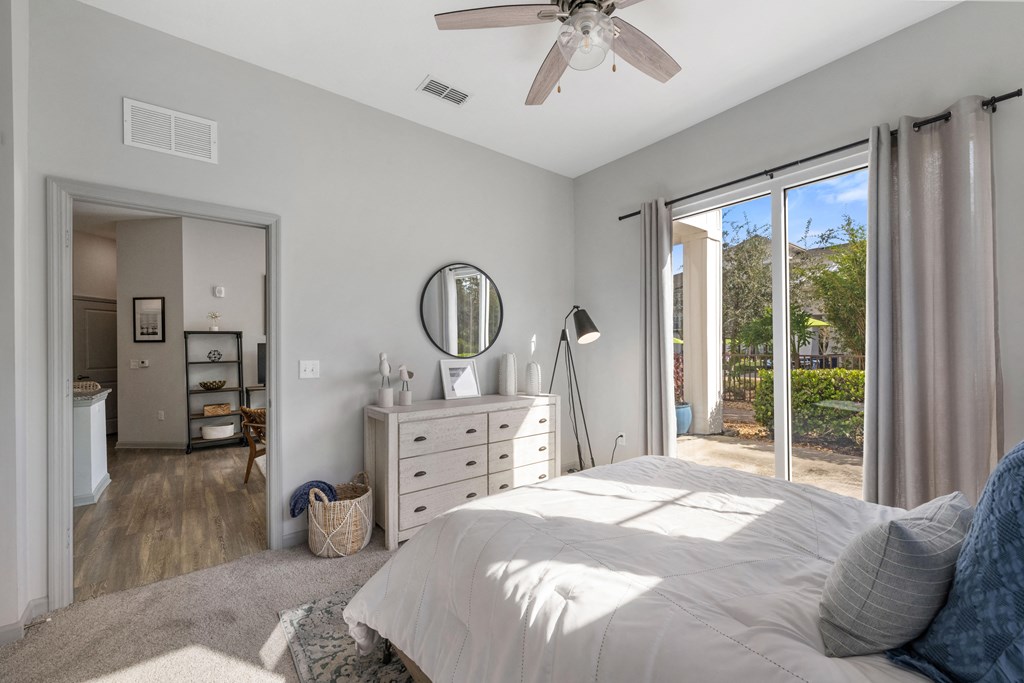 a bedroom with a bed and a ceiling fan