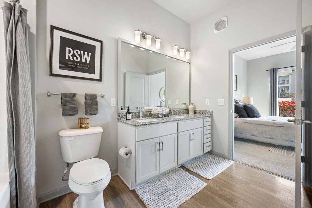 a bathroom with a mirror and a toilet and a sink