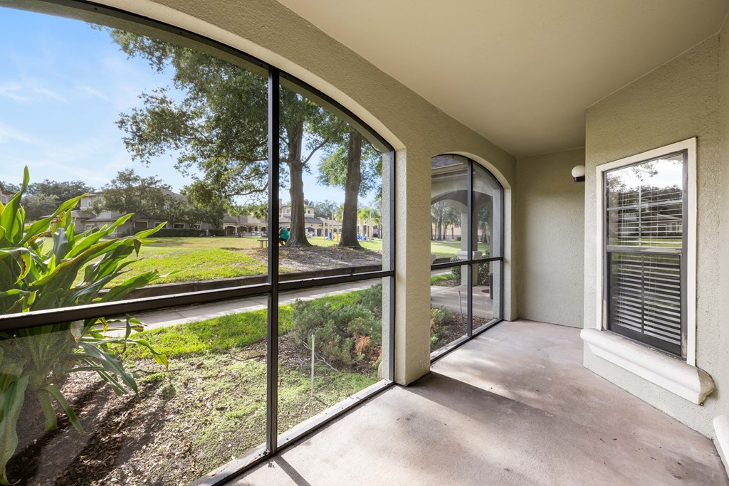a room with a large window and a view of a yard
