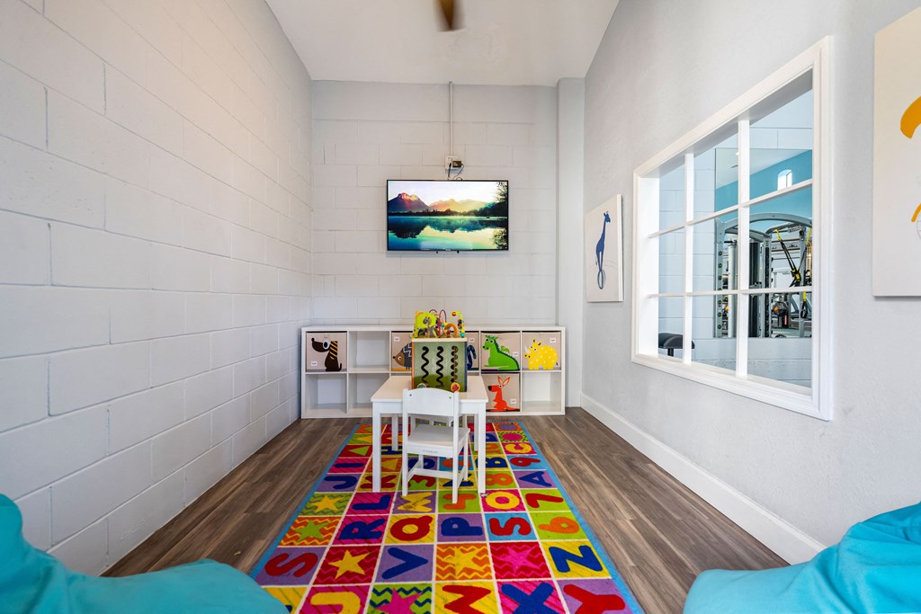a dining room with a table and chairs and a large window