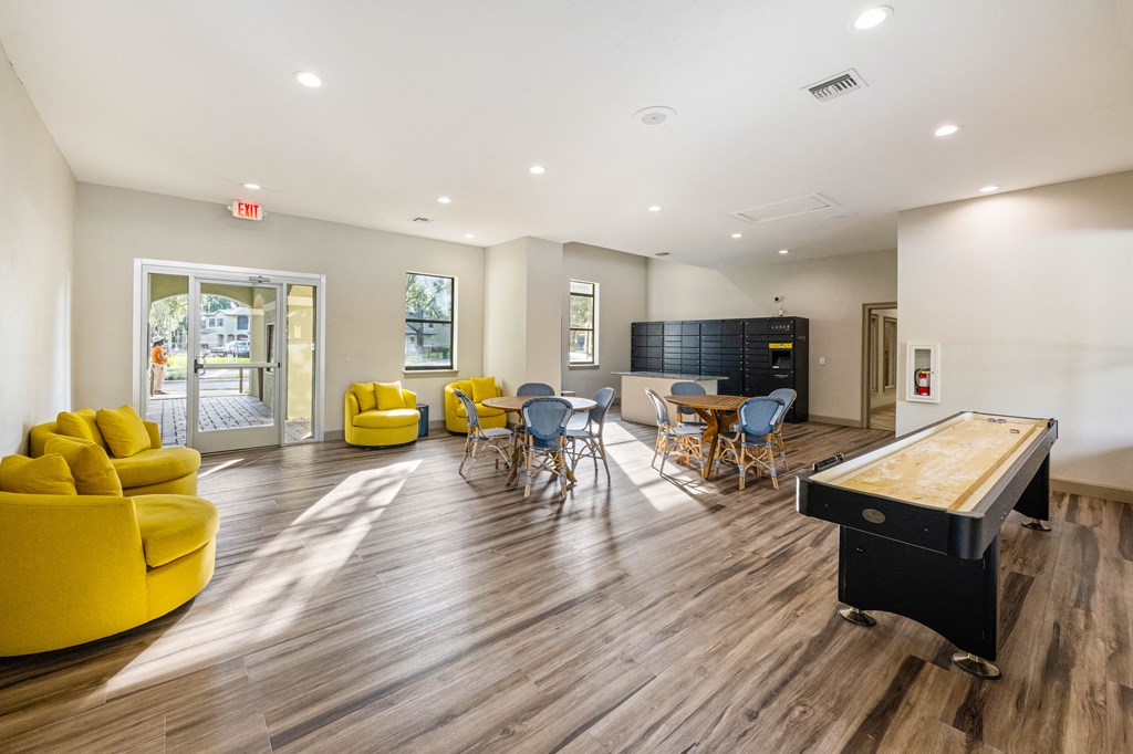 a game room with a pool table and a table and chairs
