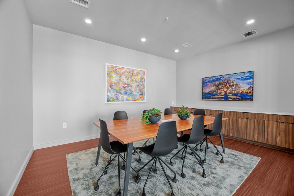a dining room with a wooden table and chairs