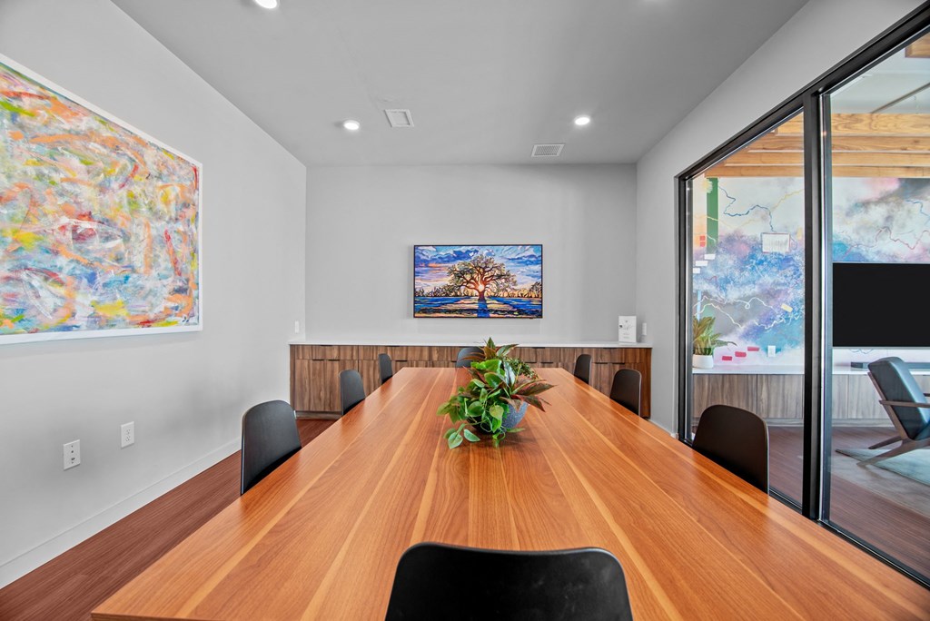a conference room with a wooden table and chairs