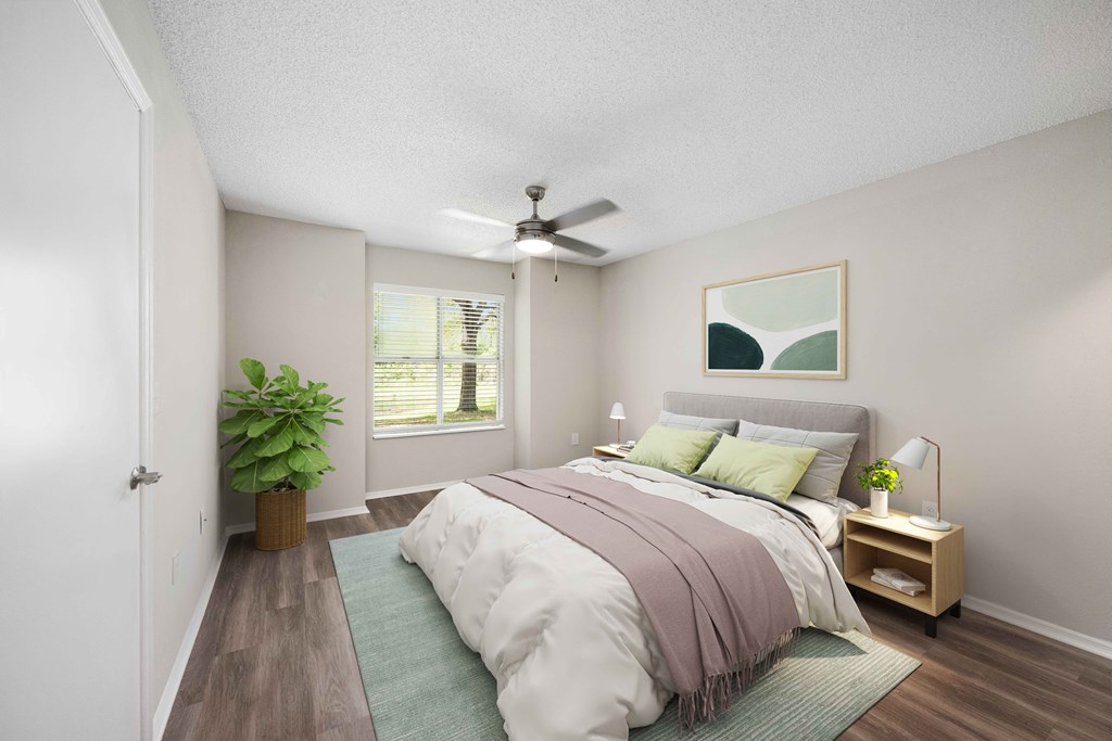 a bedroom with a bed and a ceiling fan