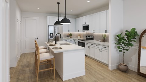 A modern kitchen with a wooden floor and white cabinetry.