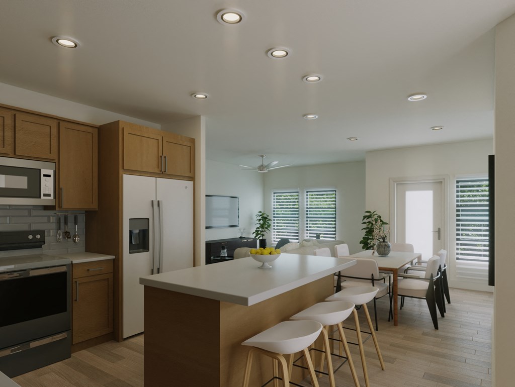 a modern kitchen with a large island and a dining table