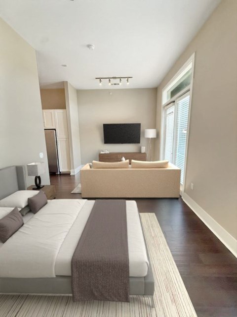 A bedroom with a large bed and a television.