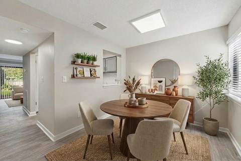 A dining room with a round table and chairs.