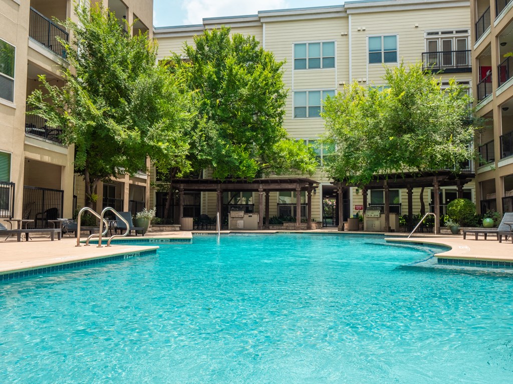 a swimming pool with a building in the background