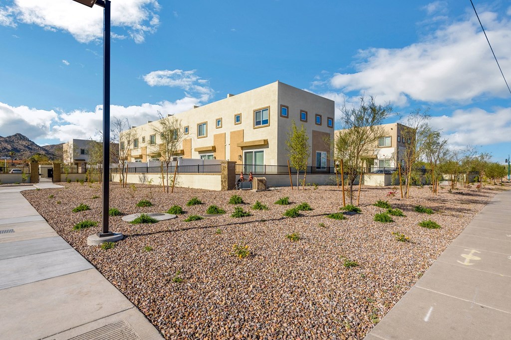 an exterior view of a building with a landscaped area
